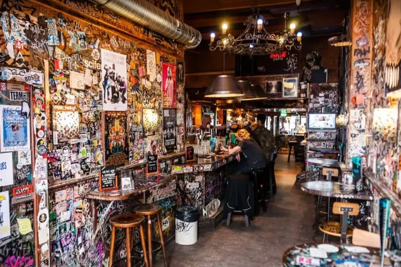 Hill Street Blues Coffeeshop Amsterdam – Iconic Graffiti-Covered Exterior by the Canal