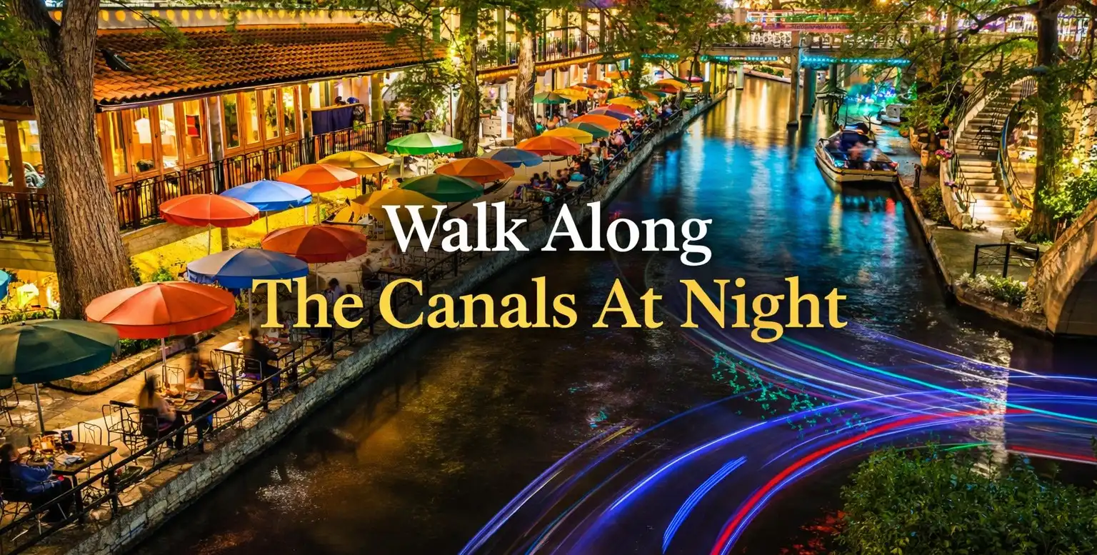 Amsterdam canals at night with illuminated bridges and historic houses